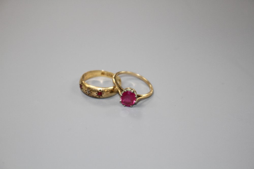 An early 20th century 18ct gold and gypsy set ruby and diamond three stone ring and one other ring.